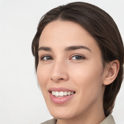 Joyful white young-adult female with medium  brown hair and brown eyes