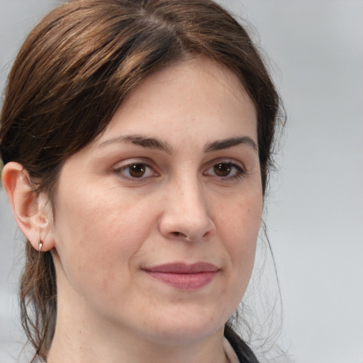 Joyful white adult female with medium  brown hair and brown eyes