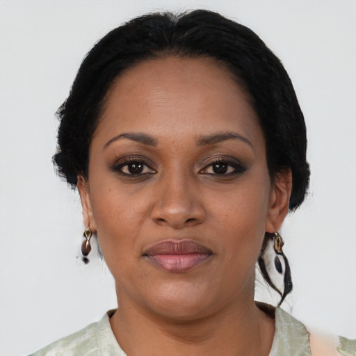 Joyful black adult female with medium  black hair and brown eyes