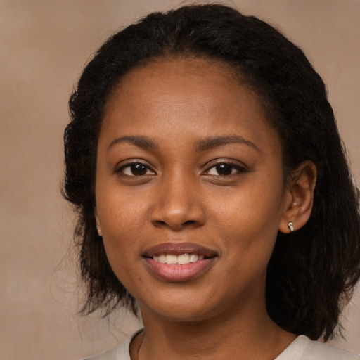 Joyful black young-adult female with medium  brown hair and brown eyes