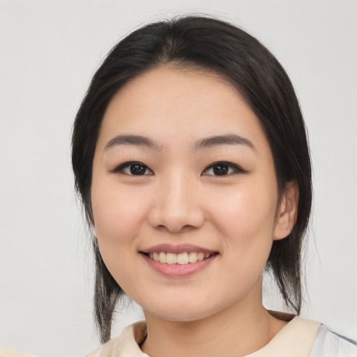 Joyful white young-adult female with medium  black hair and brown eyes