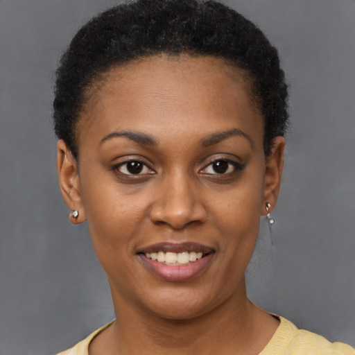 Joyful black young-adult female with short  brown hair and brown eyes