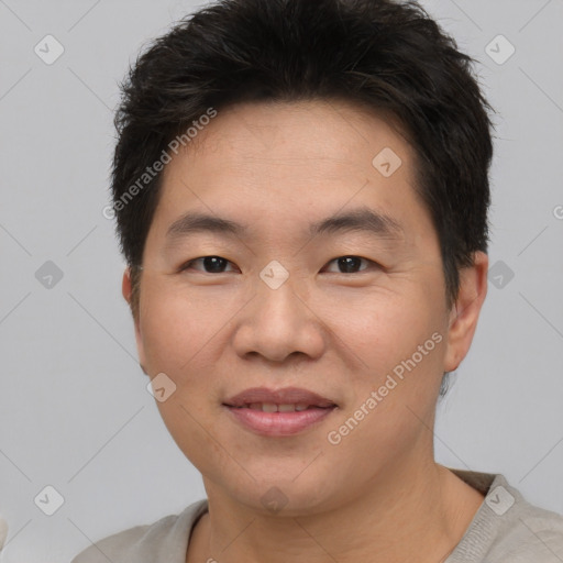 Joyful asian young-adult male with short  brown hair and brown eyes