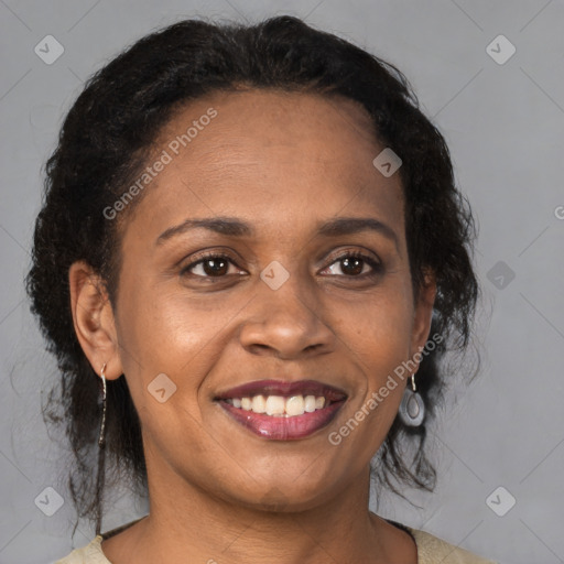 Joyful black adult female with medium  brown hair and brown eyes