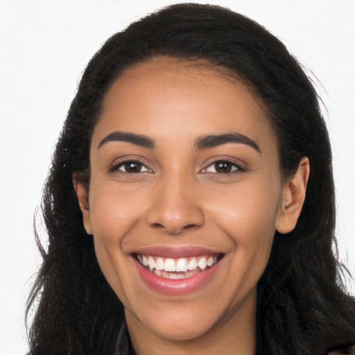 Joyful latino young-adult female with long  black hair and brown eyes