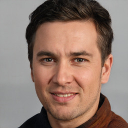 Joyful white adult male with short  brown hair and grey eyes