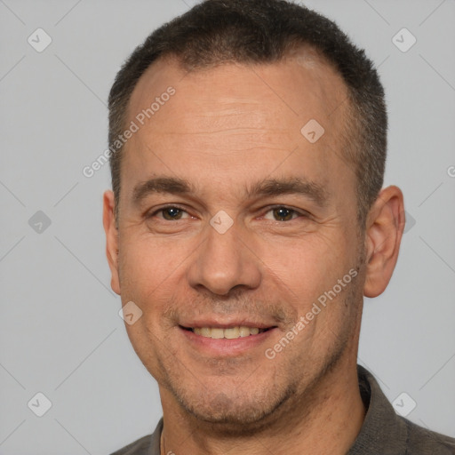 Joyful white adult male with short  brown hair and brown eyes