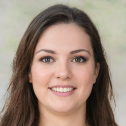 Joyful white young-adult female with long  brown hair and green eyes