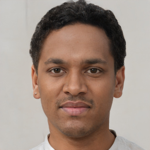 Joyful black young-adult male with short  black hair and brown eyes