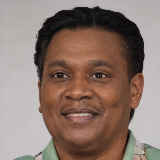 Joyful latino adult male with short  brown hair and brown eyes