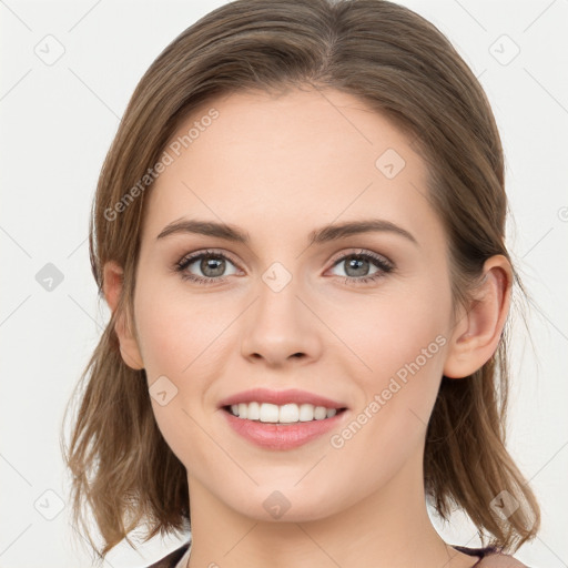 Joyful white young-adult female with medium  brown hair and blue eyes