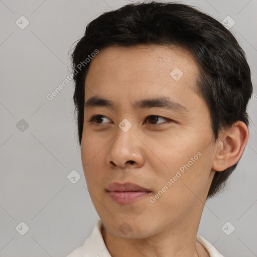 Joyful white young-adult male with short  black hair and brown eyes