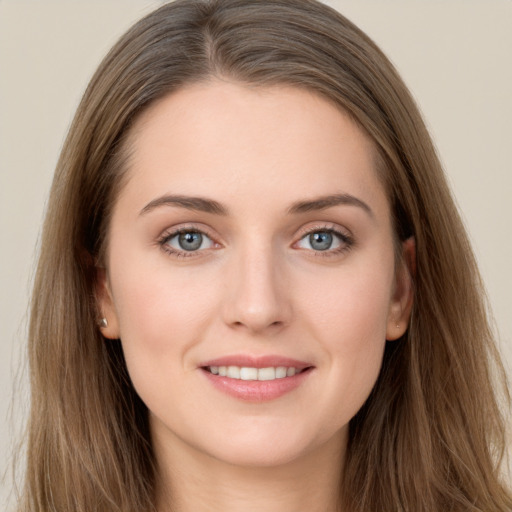 Joyful white young-adult female with long  brown hair and grey eyes