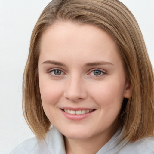 Joyful white young-adult female with medium  brown hair and blue eyes