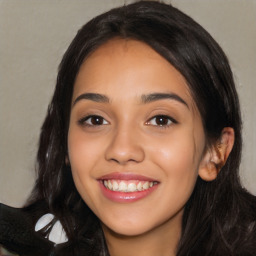 Joyful latino young-adult female with long  black hair and brown eyes