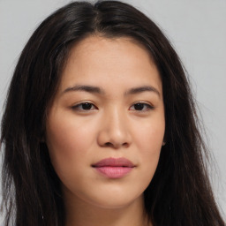 Joyful asian young-adult female with long  brown hair and brown eyes