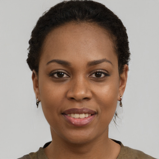 Joyful black young-adult female with short  brown hair and brown eyes