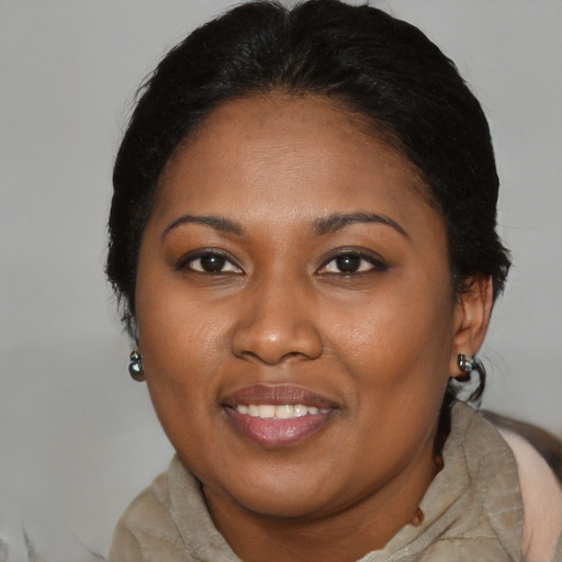 Joyful black young-adult female with medium  brown hair and brown eyes