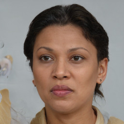 Joyful black adult female with medium  brown hair and brown eyes