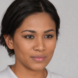 Joyful latino young-adult female with medium  brown hair and brown eyes