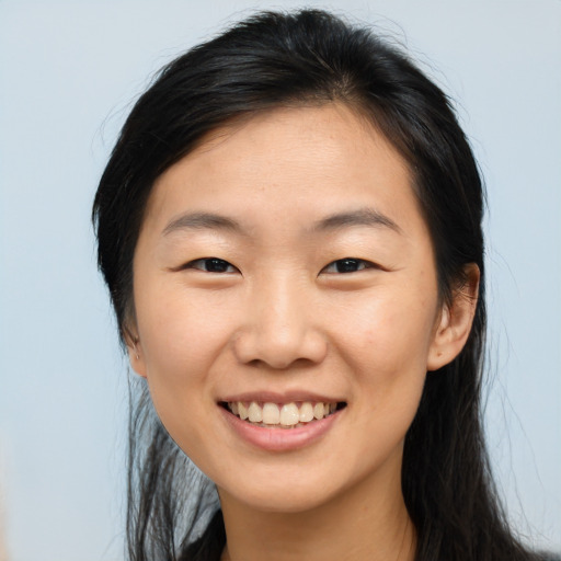 Joyful asian young-adult female with long  brown hair and brown eyes