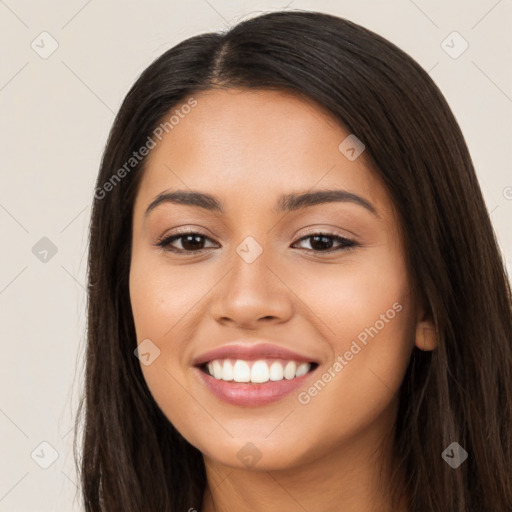 Joyful latino young-adult female with long  brown hair and brown eyes