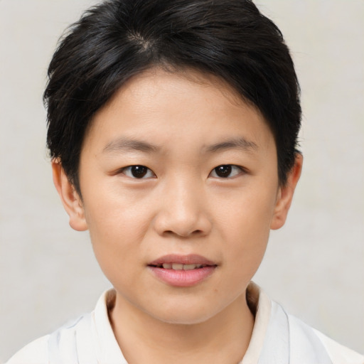 Joyful asian child female with short  brown hair and brown eyes