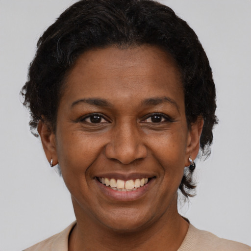 Joyful black adult female with short  black hair and brown eyes