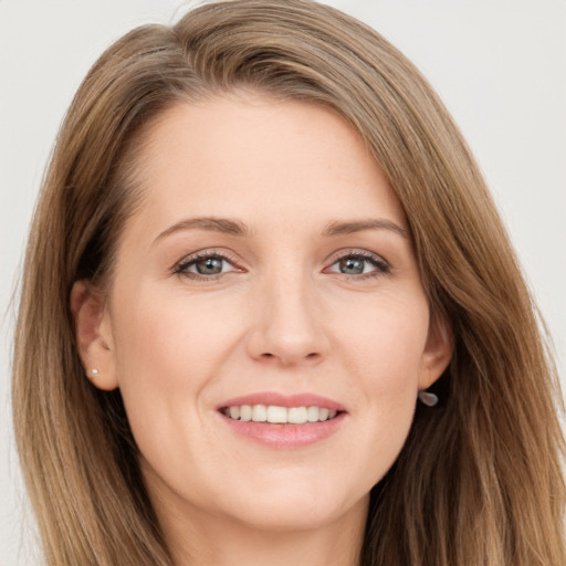 Joyful white young-adult female with long  brown hair and brown eyes