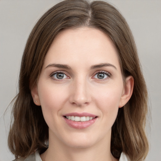 Joyful white young-adult female with medium  brown hair and grey eyes