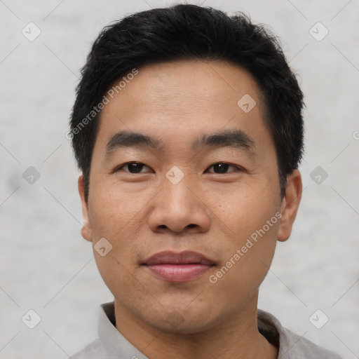 Joyful asian young-adult male with short  black hair and brown eyes