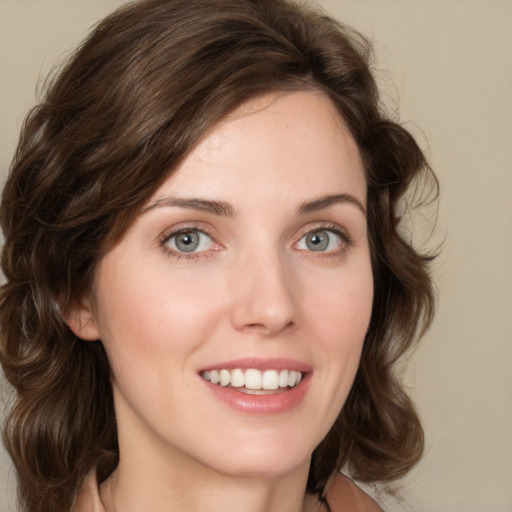 Joyful white young-adult female with medium  brown hair and green eyes