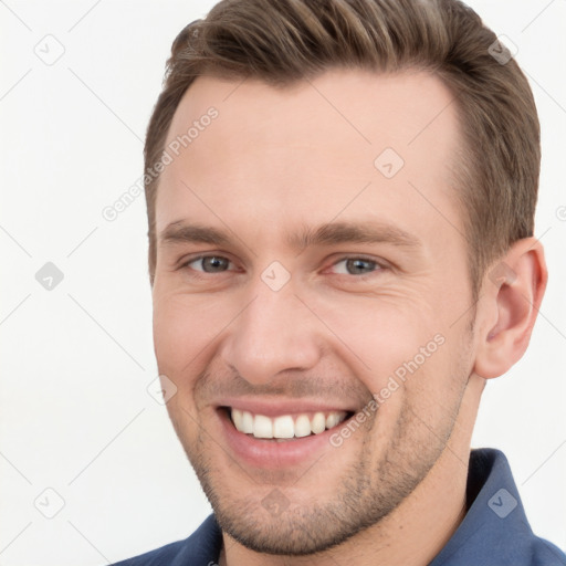 Joyful white young-adult male with short  brown hair and brown eyes