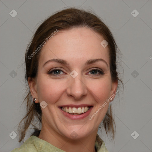 Joyful white adult female with medium  brown hair and blue eyes