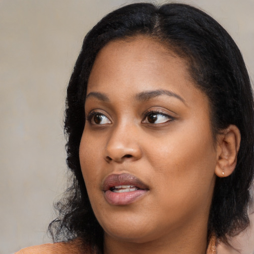Joyful black young-adult female with medium  black hair and brown eyes