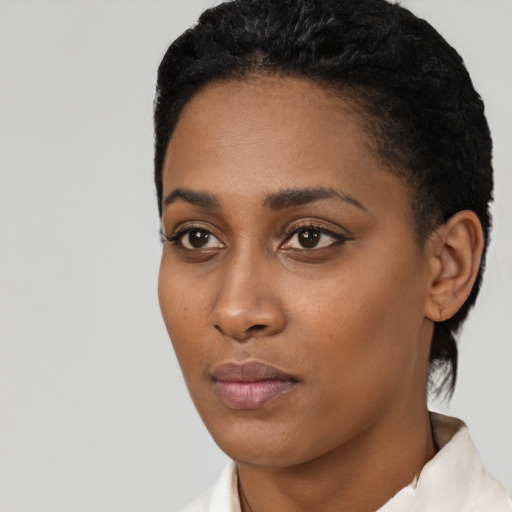 Neutral black young-adult female with short  black hair and brown eyes