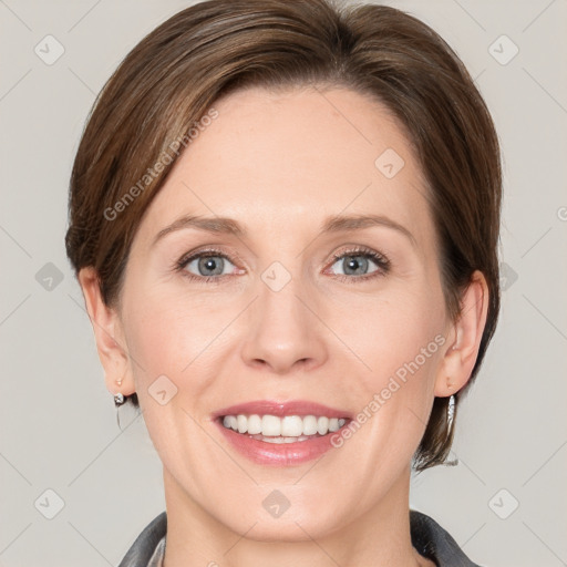 Joyful white adult female with medium  brown hair and grey eyes