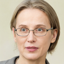 Joyful white adult female with medium  brown hair and blue eyes