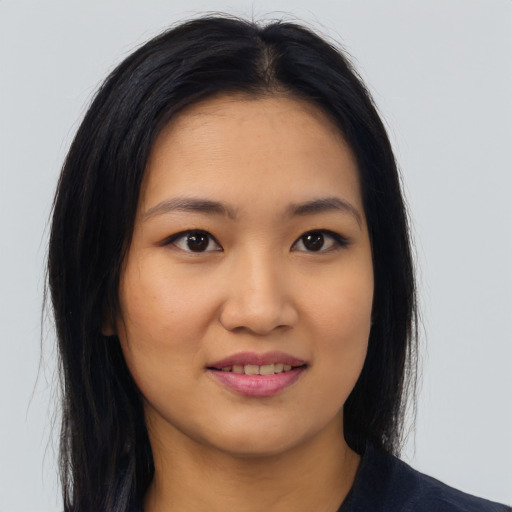 Joyful asian young-adult female with long  brown hair and brown eyes