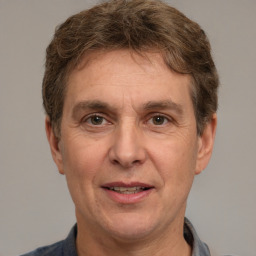 Joyful white middle-aged male with short  brown hair and brown eyes