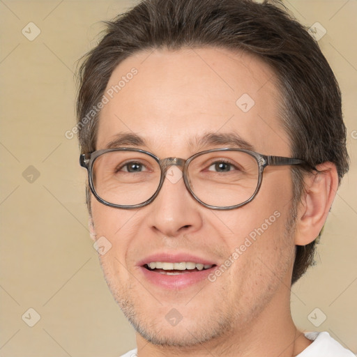 Joyful white adult male with short  brown hair and brown eyes