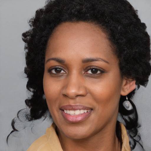 Joyful black young-adult female with medium  black hair and brown eyes