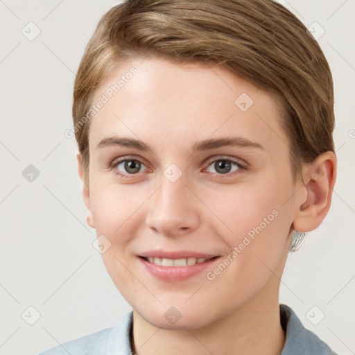 Joyful white young-adult female with short  brown hair and grey eyes