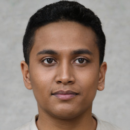 Joyful latino young-adult male with short  black hair and brown eyes
