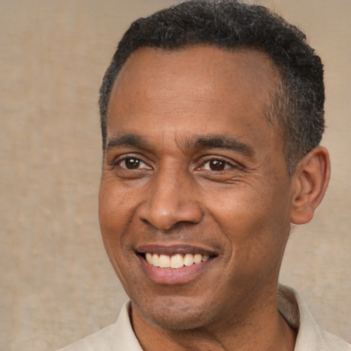 Joyful latino adult male with short  brown hair and brown eyes