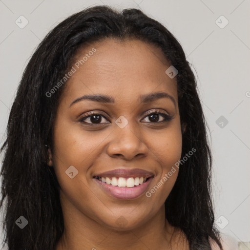 Joyful black young-adult female with long  brown hair and brown eyes