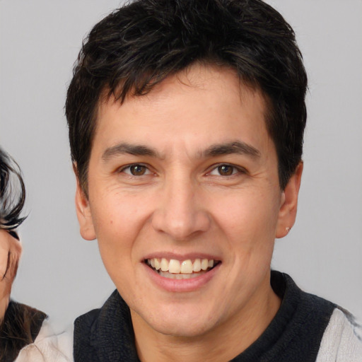 Joyful white young-adult male with medium  brown hair and brown eyes