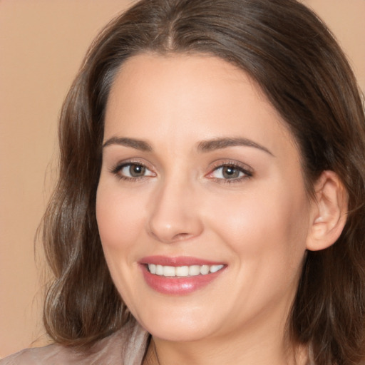 Joyful white young-adult female with long  brown hair and brown eyes