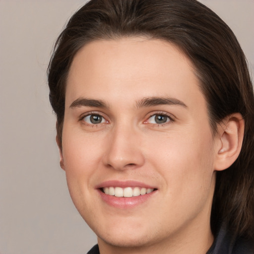 Joyful white young-adult male with medium  brown hair and brown eyes