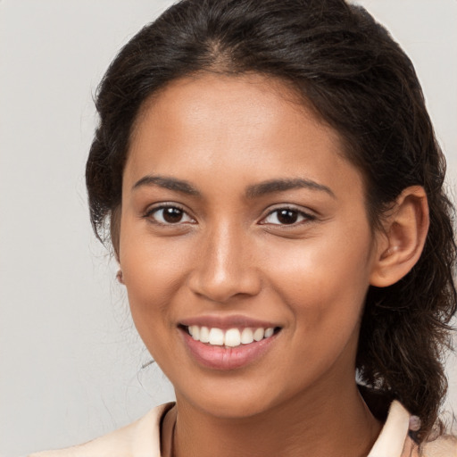 Joyful white young-adult female with long  brown hair and brown eyes